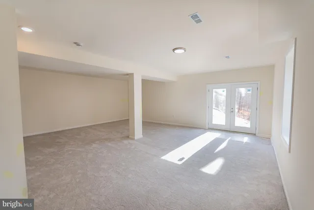 a view of empty room with wooden walls