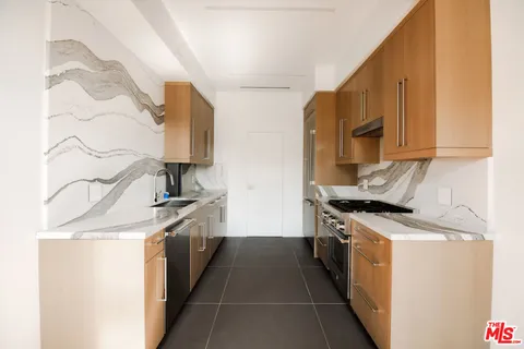 a kitchen with stainless steel appliances granite countertop a stove and a sink