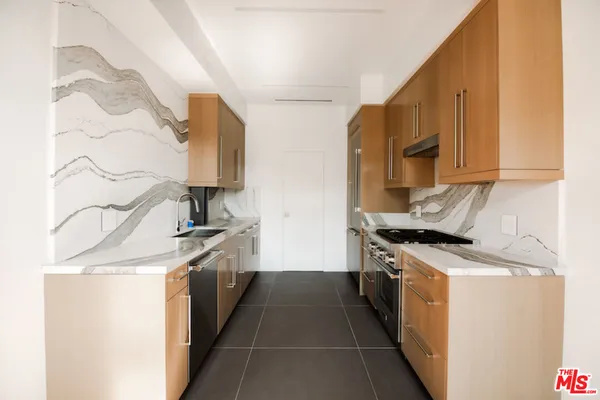 a kitchen with stainless steel appliances granite countertop a stove and a sink