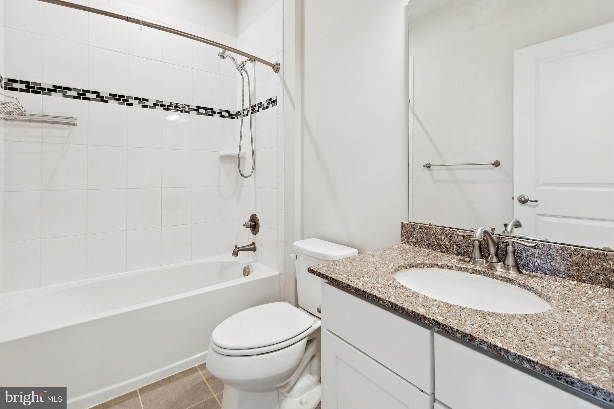 5329 Woodyard Road Upper Marlboro, MD 20772 - Photo 15 of 25 a bathroom with a granite countertop sink a toilet and shower