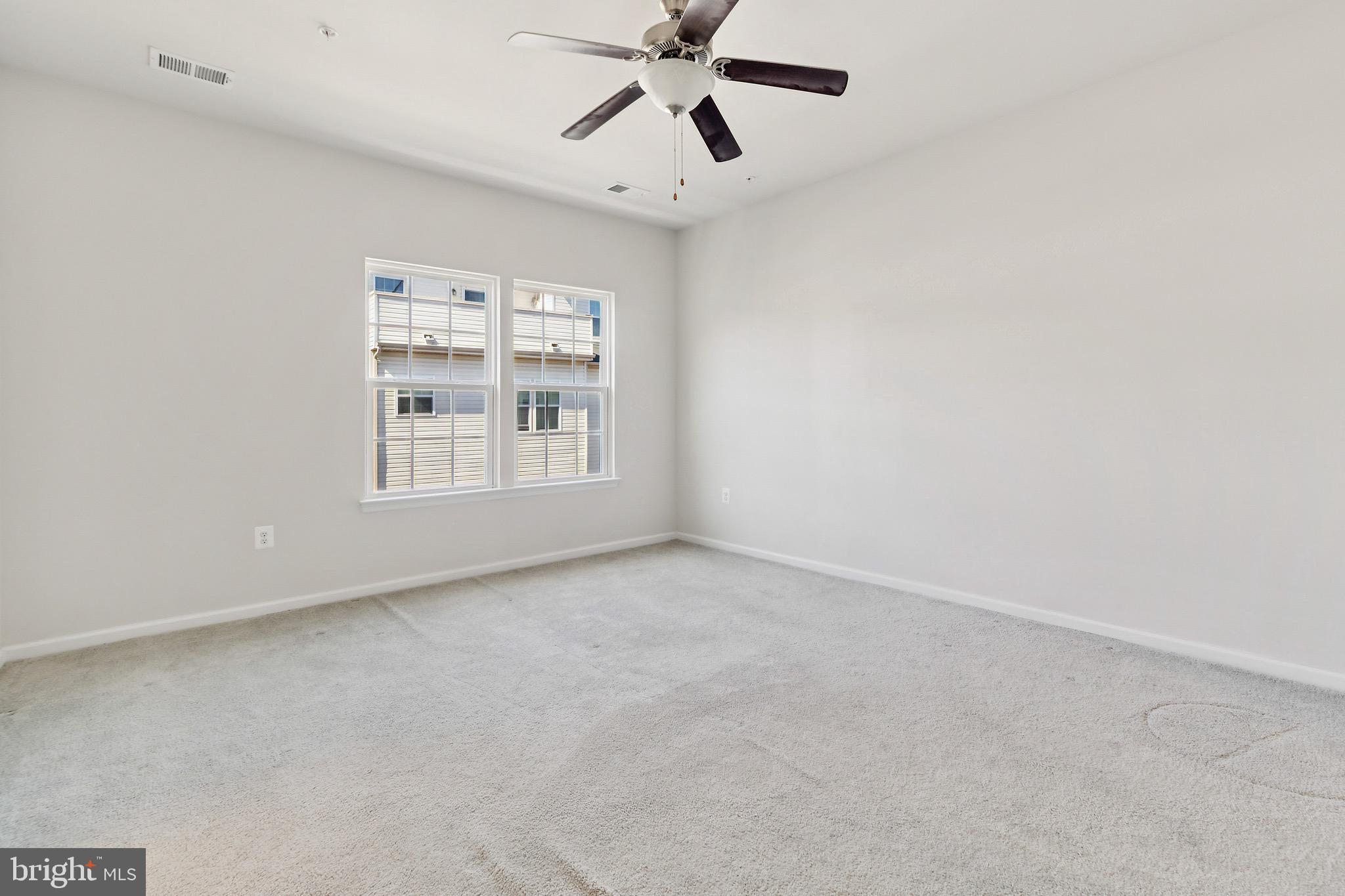 5329 Woodyard Road Upper Marlboro, MD 20772 - Photo 19 of 25 an empty room with windows and ceiling fan