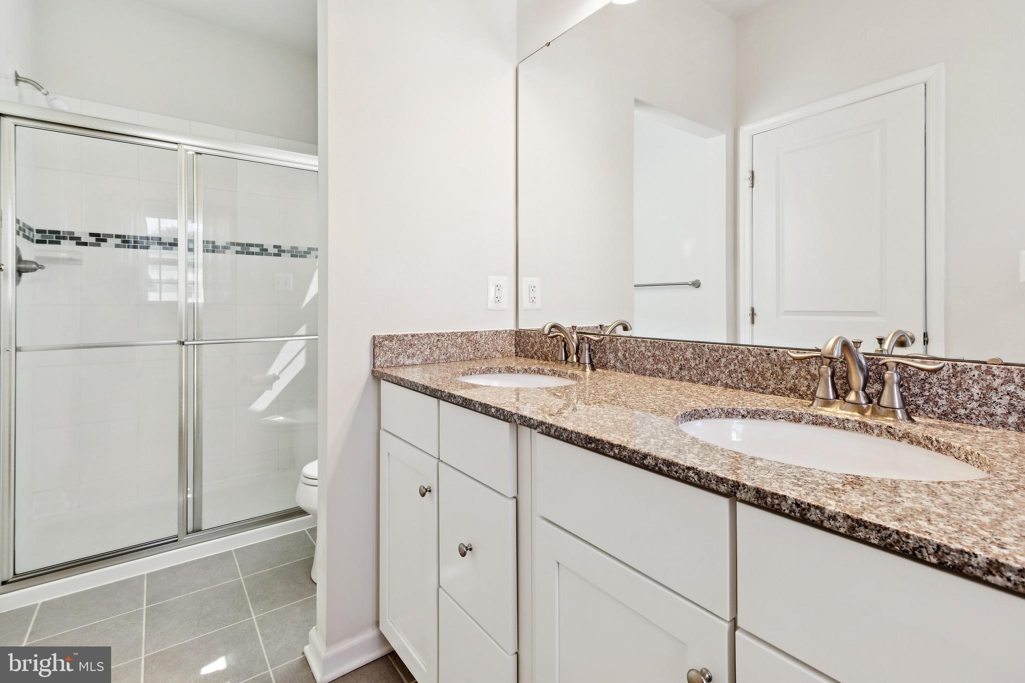 5329 Woodyard Road Upper Marlboro, MD 20772 - Photo 22 of 25 a bathroom with a granite countertop sink and a mirror