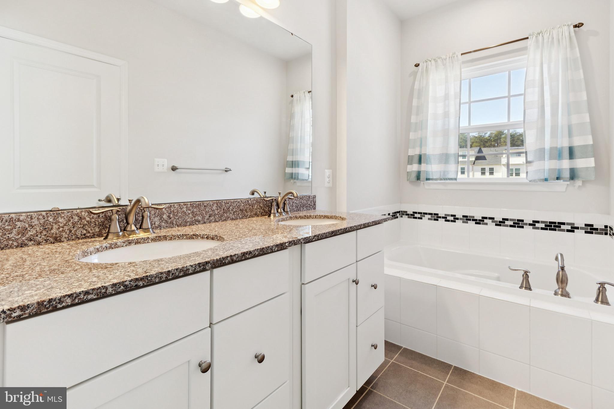 5329 Woodyard Road Upper Marlboro, MD 20772 - Photo 23 of 25 a bathroom with a granite countertop sink and a bathtub