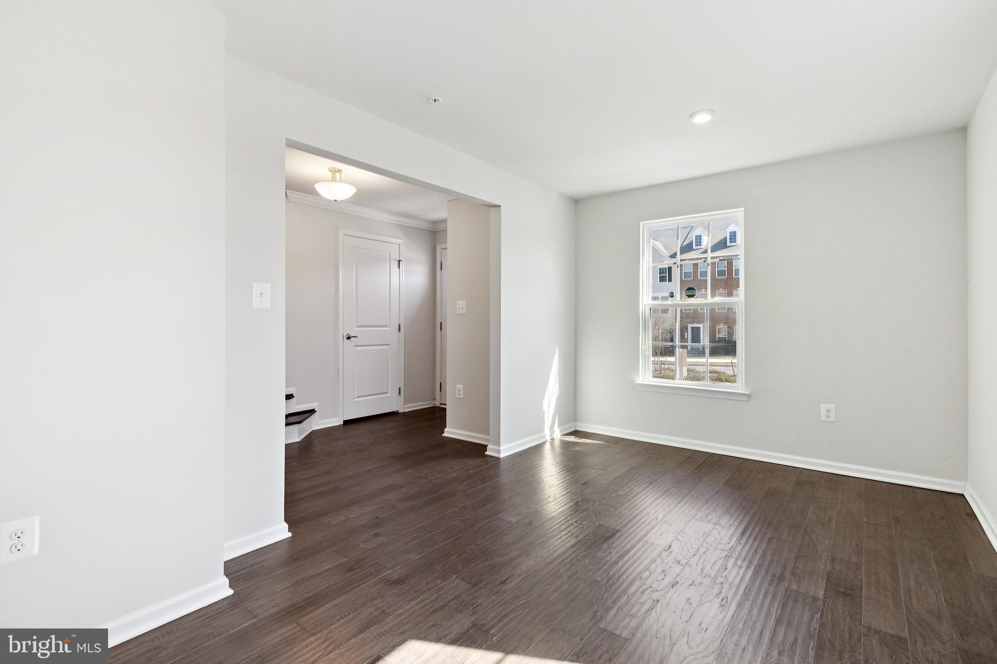 5329 Woodyard Road Upper Marlboro, MD 20772 - Photo 6 of 25 an empty room with wooden floor and windows