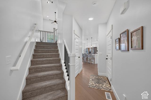 4751 Heartwood Road Mapleton, UT 84664 - Photo 4 of 33 Carpeted staircase with white handrails and black balusters