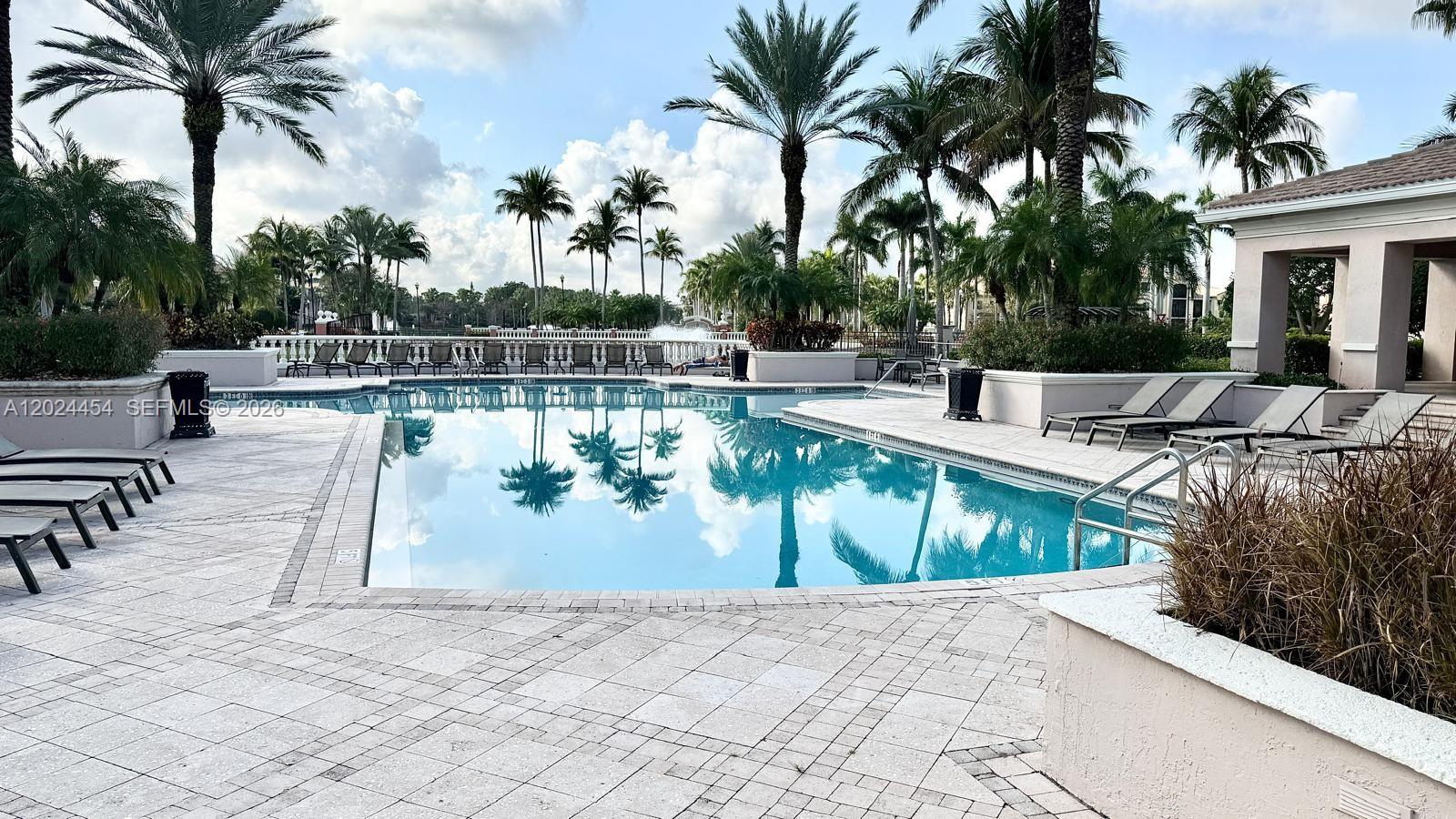 2727 Anzio Court, Unit 106 Palm Beach Gardens, FL 33410 - Photo 30 of 43 a view of a swimming pool with chairs