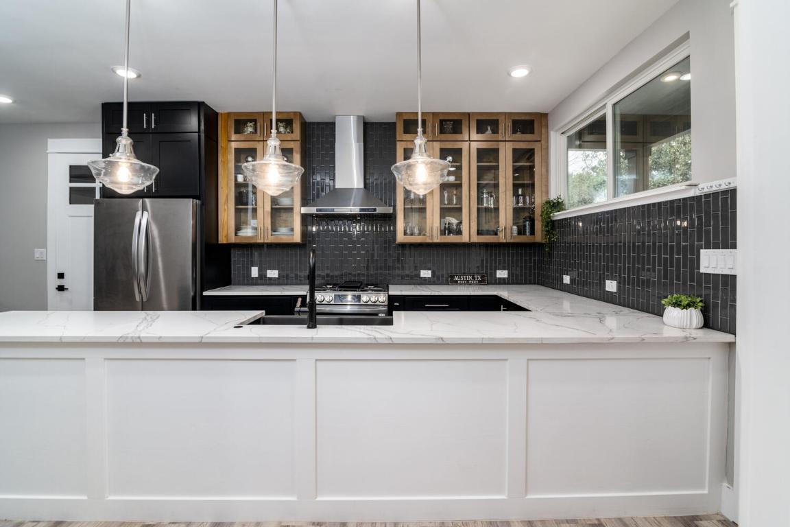 7905-7907 Tiffany Drive Austin, TX 78749 - Photo 1 of 37 a kitchen with stainless steel appliances kitchen island granite countertop a sink and a refrigerator