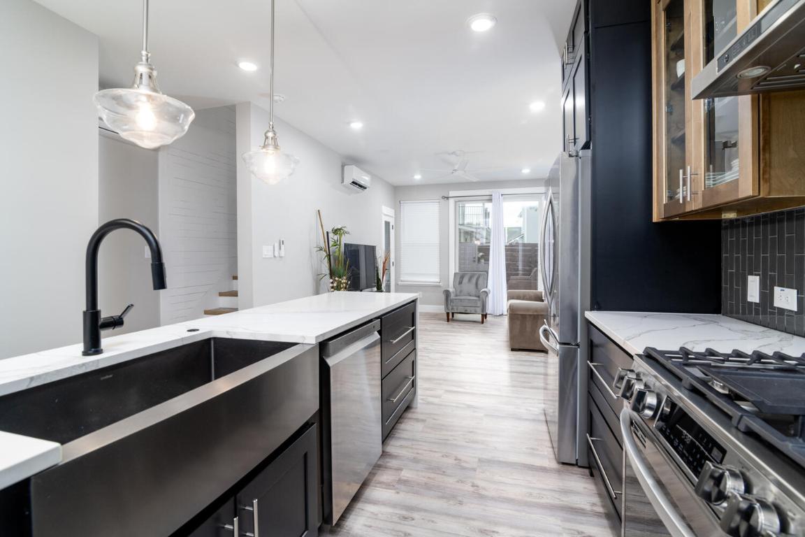 7905-7907 Tiffany Drive Austin, TX 78749 - Photo 11 of 37 a kitchen with stainless steel appliances granite countertop a sink stove and cabinets