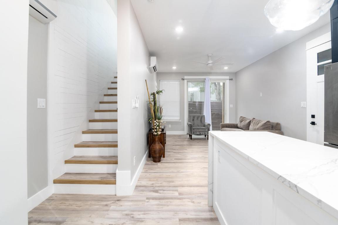7905-7907 Tiffany Drive Austin, TX 78749 - Photo 13 of 37 a room with lots of white furniture and stairs