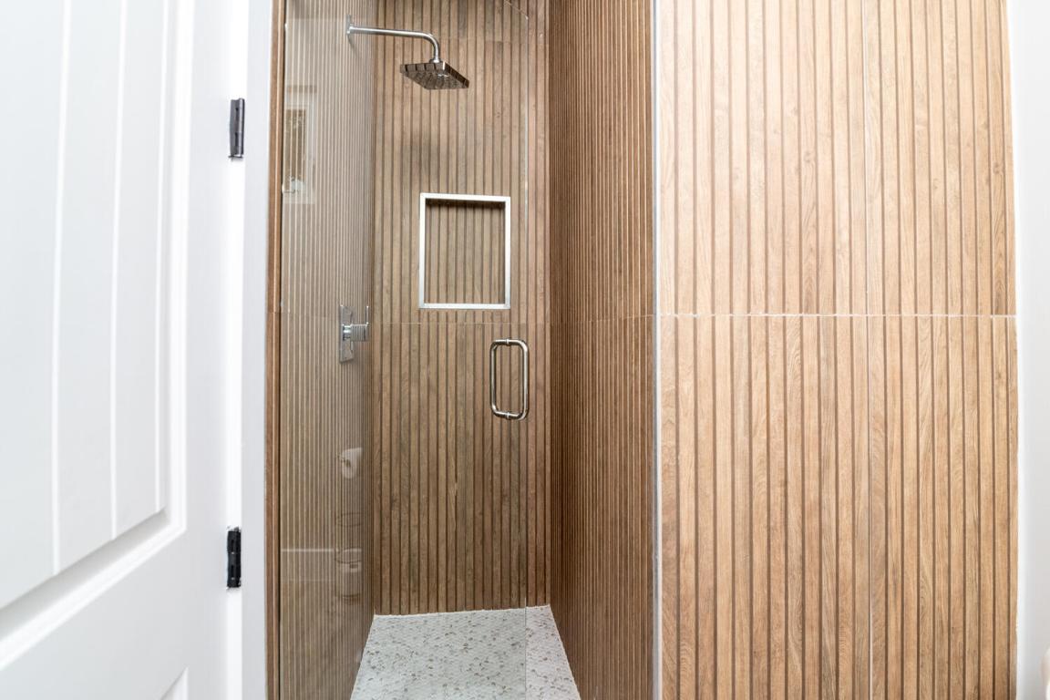 7905-7907 Tiffany Drive Austin, TX 78749 - Photo 15 of 37 a bathroom with a glass door