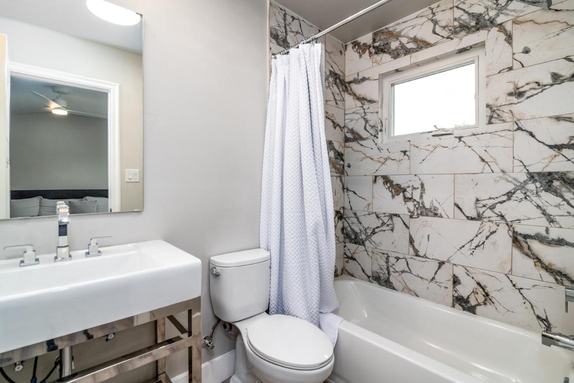 7905-7907 Tiffany Drive Austin, TX 78749 - Photo 23 of 37 a bathroom with a sink toilet and shower