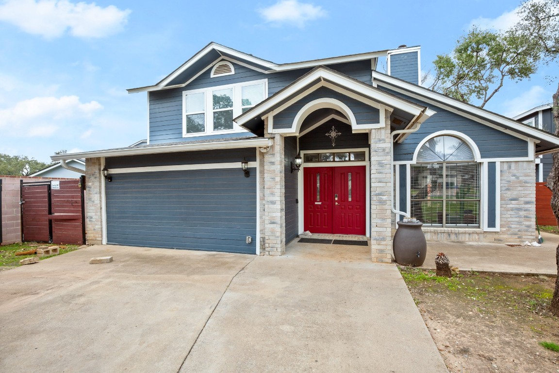 7905-7907 Tiffany Drive Austin, TX 78749 - Photo 3 of 37 a front view of a house with garage and parking space