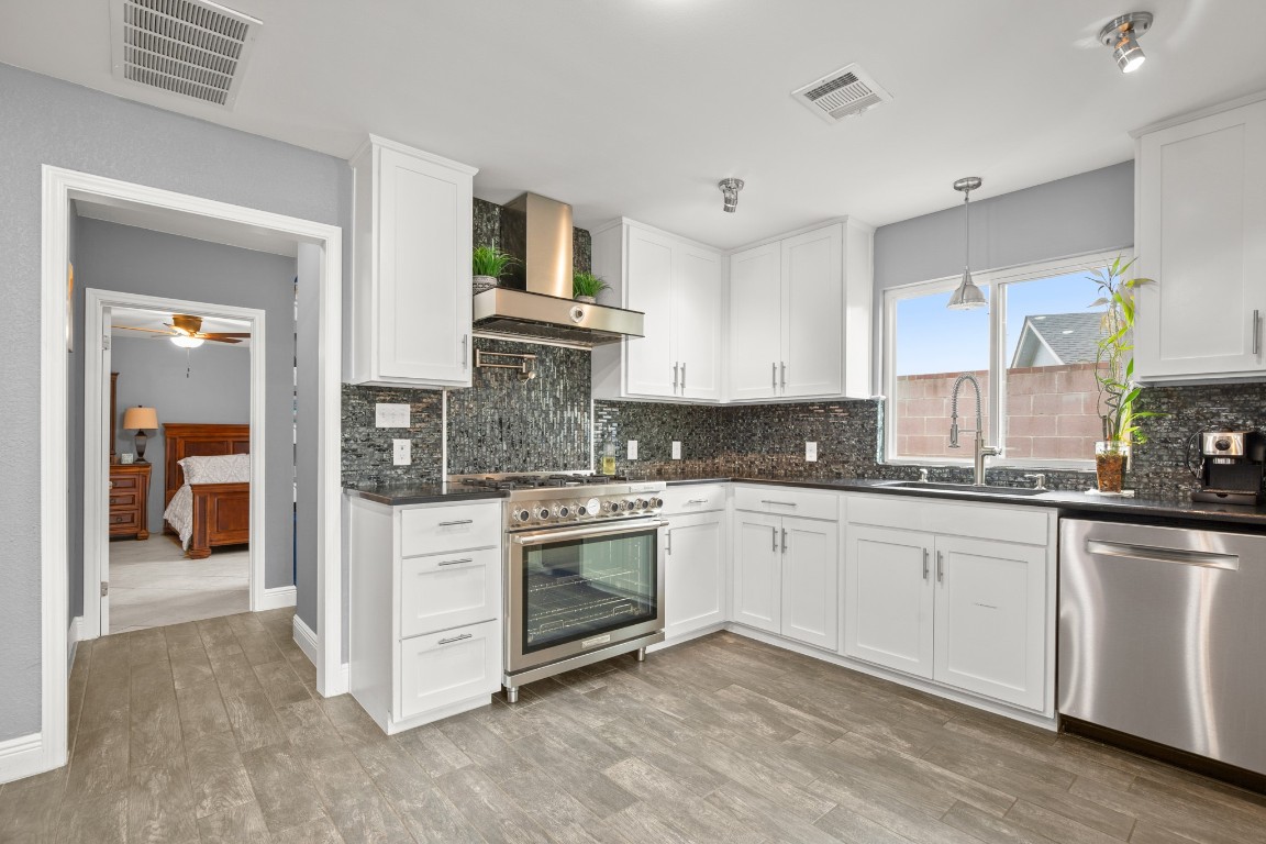 7905-7907 Tiffany Drive Austin, TX 78749 - Photo 32 of 37 a kitchen with granite countertop a sink and cabinets