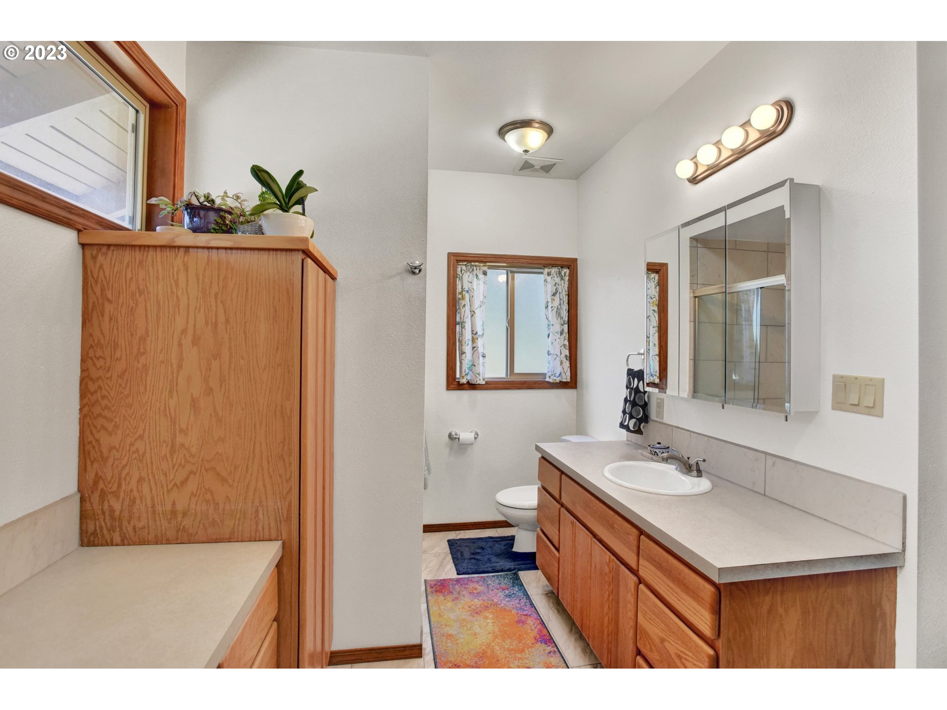 43011 Southeast Keisecker Road Sandy, OR 97055 - Photo 17 of 48 a bathroom with a sink a mirror and a toilet