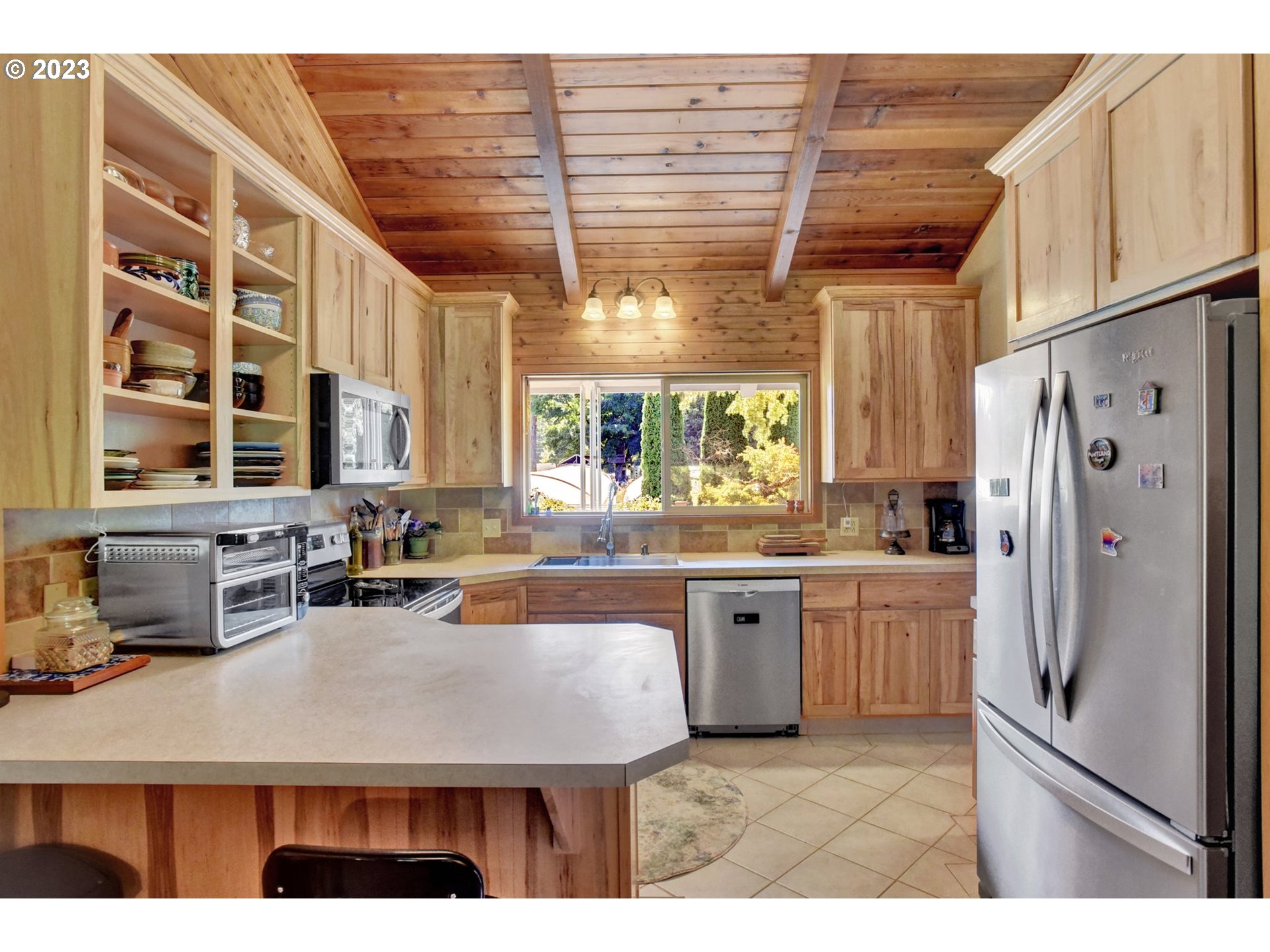 43011 Southeast Keisecker Road Sandy, OR 97055 - Photo 6 of 48 a kitchen with stainless steel appliances granite countertop a refrigerator a sink dishwasher and white cabinets with wooden floor