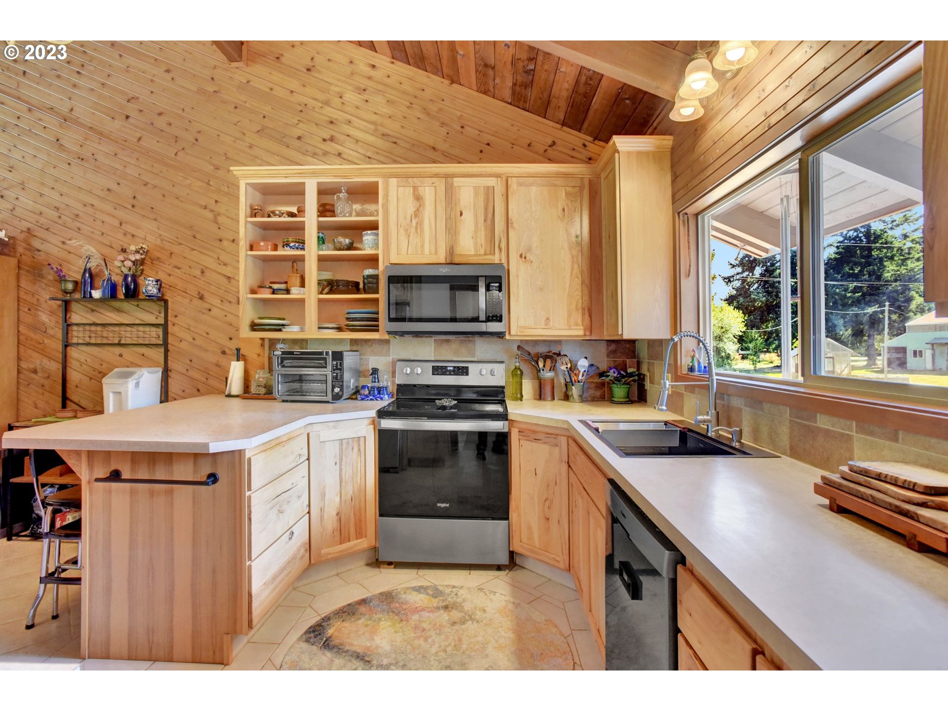 43011 Southeast Keisecker Road Sandy, OR 97055 - Photo 10 of 48 a kitchen with a stove a sink and a microwave