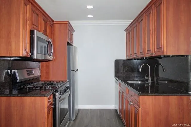 a kitchen with stainless steel appliances granite countertop a sink stove and refrigerator