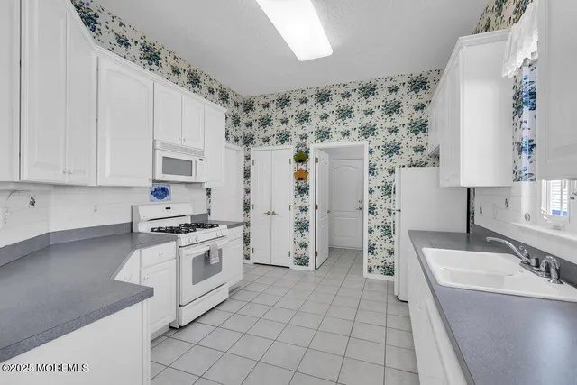a kitchen with stainless steel appliances a stove a sink and a refrigerator