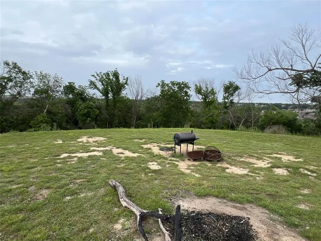 a view of a green field with wooden fence
