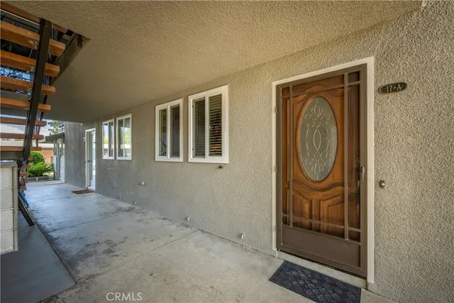 a living room with furniture a couch and potted plants