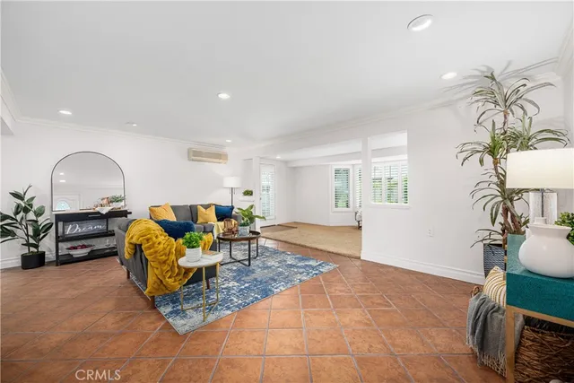 a living room with furniture kitchen view and a rug