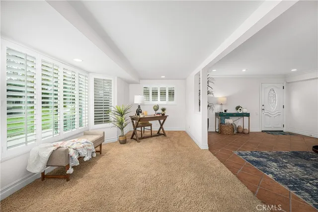 a view of a dining room with furniture and a potted plant