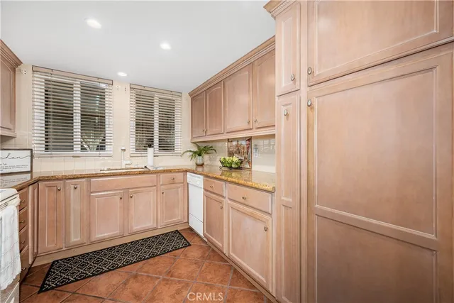 a kitchen with stainless steel appliances white cabinets and a refrigerator