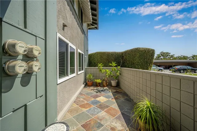 a view of a balcony with wooden floor and iron fence