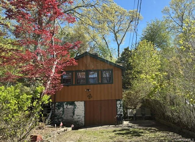 40 Hawthorne Road Rocky Point, NY 11778 - Photo 3 of 19 a front view of a house with a yard