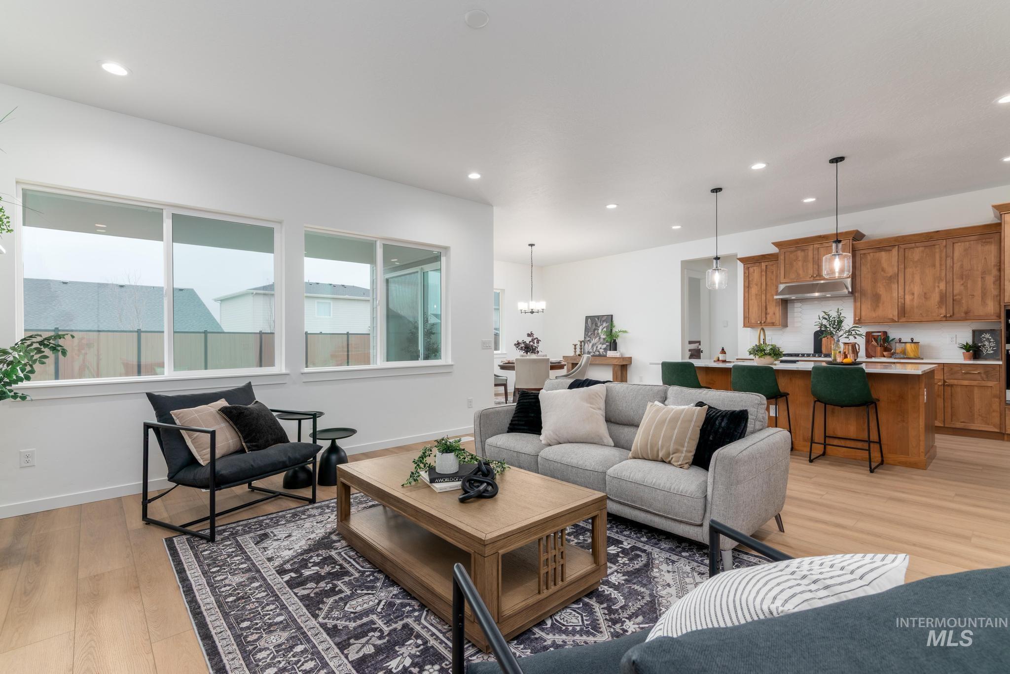 9767 West Nicasio Drive Star, ID 83669 - Photo 3 of 12 Living area featuring light wood-type flooring, recessed lighting, and a chandelier