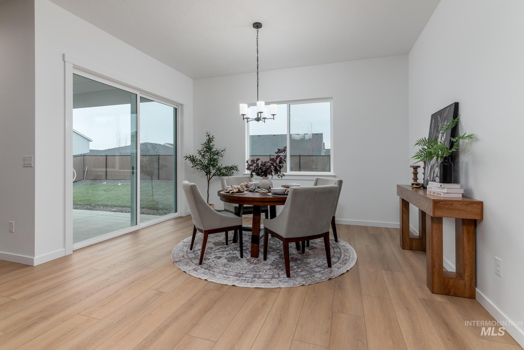 9767 West Nicasio Drive Star, ID 83669 - Photo 6 of 12 Dining space featuring light wood-style flooring and a chandelier