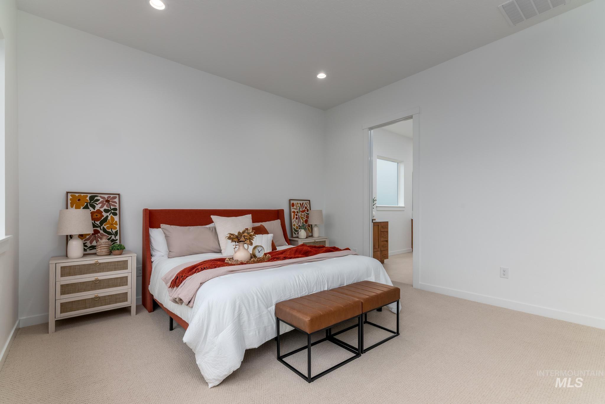 9767 West Nicasio Drive Star, ID 83669 - Photo 7 of 12 Bedroom with light colored carpet, recessed lighting, and connected bathroom