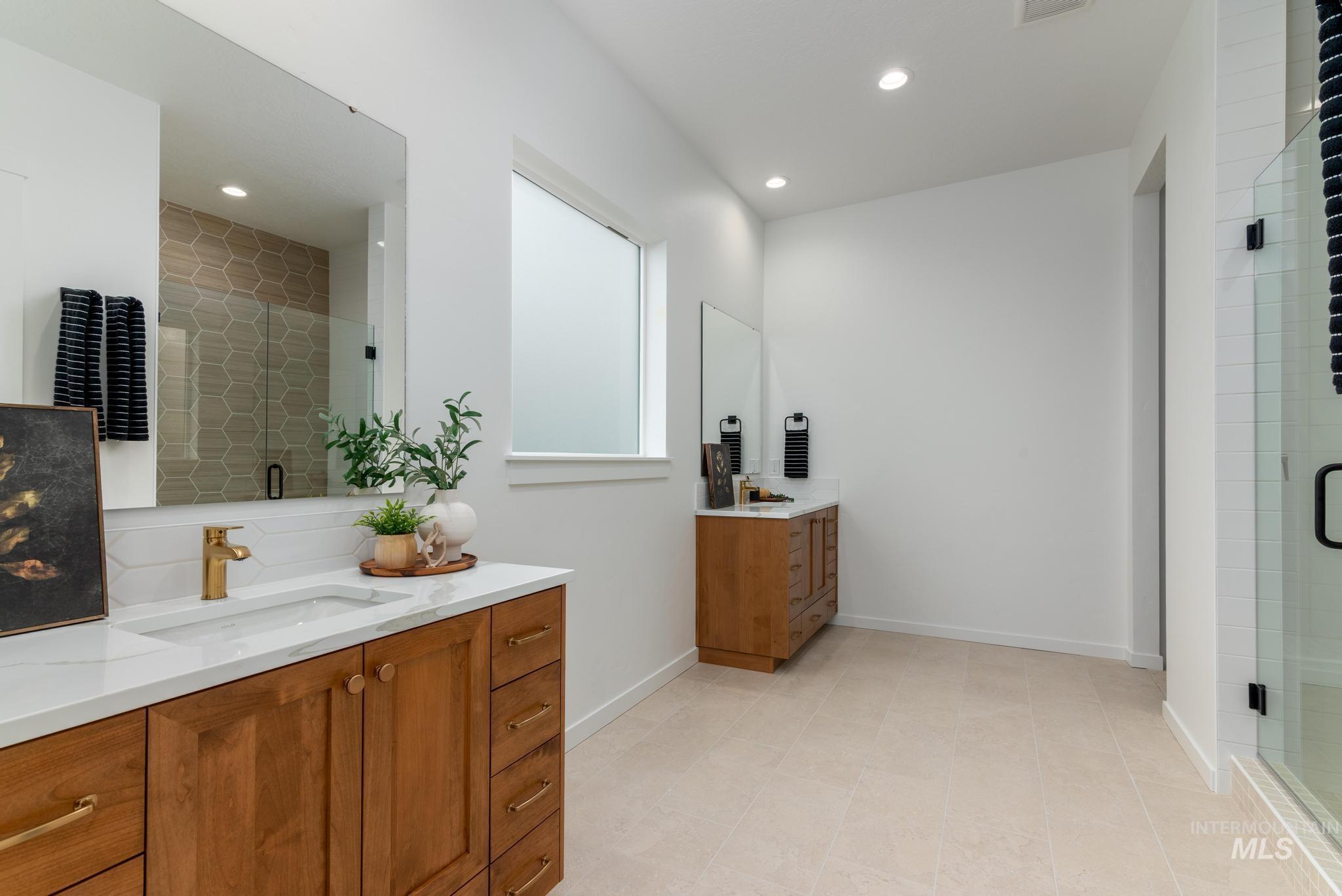 9767 West Nicasio Drive Star, ID 83669 - Photo 9 of 12 Full bath with two vanities, a stall shower, recessed lighting, and tasteful backsplash