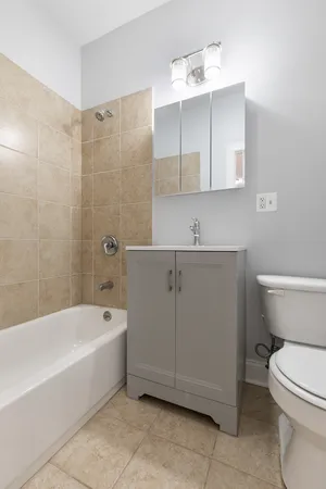 a bathroom with a sink a toilet and bathtub