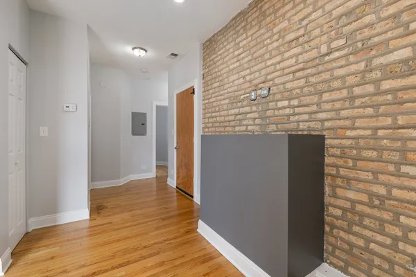a view of hallway with wooden floor