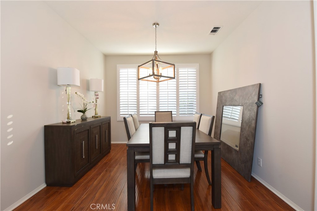 24 Silveroak Irvine, CA 92620 - Photo 11 of 64 a view of a dining room with furniture window and wooden floor