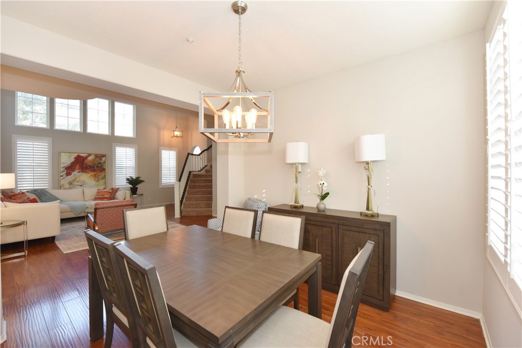 24 Silveroak Irvine, CA 92620 - Photo 12 of 64 a view of a dining room with furniture window and wooden floor