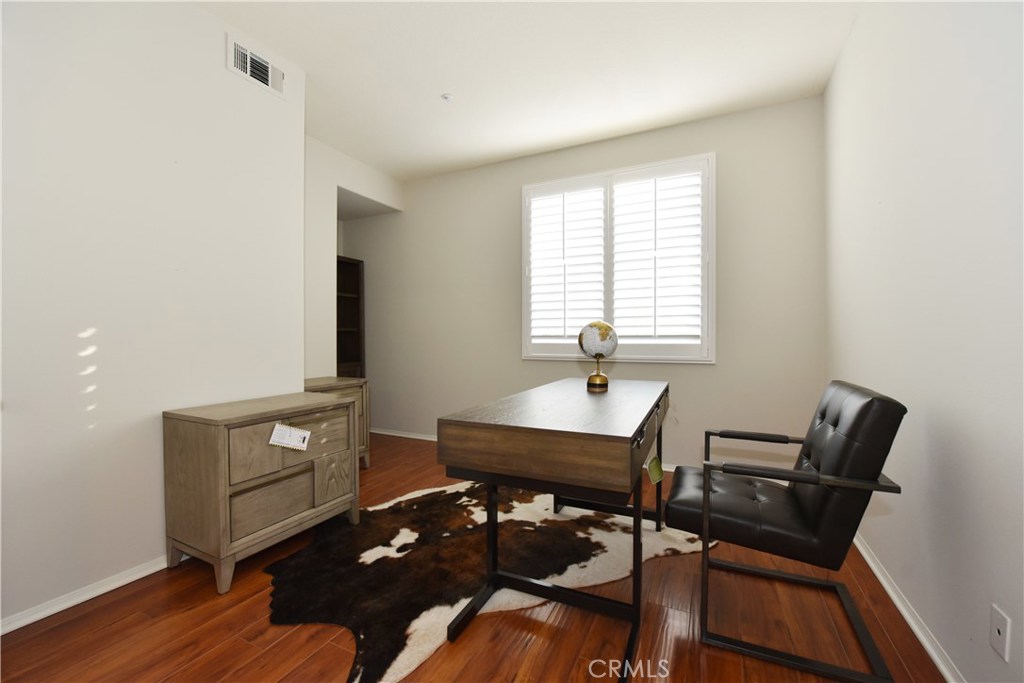 24 Silveroak Irvine, CA 92620 - Photo 3 of 64 a view of a workspace with furniture and wooden floor