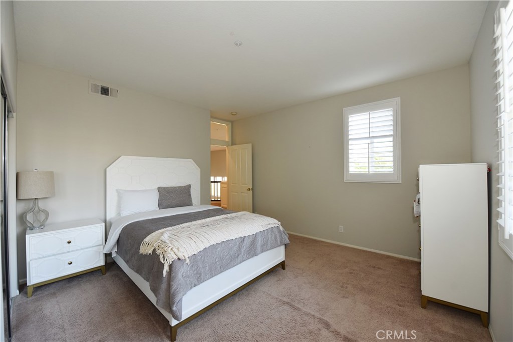24 Silveroak Irvine, CA 92620 - Photo 32 of 64 a bedroom with a bed and a white wall