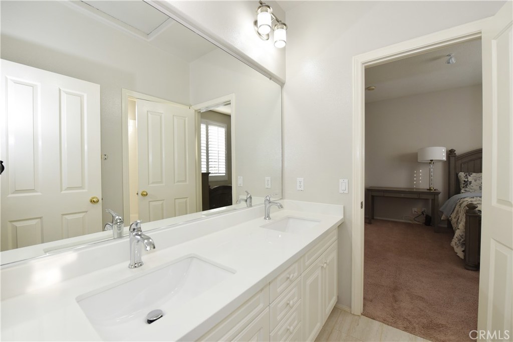 24 Silveroak Irvine, CA 92620 - Photo 35 of 64 a en suite bathroom with a double vanity sink and a mirror