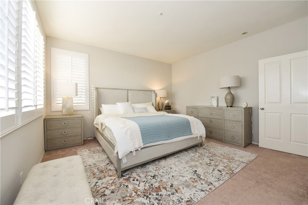 24 Silveroak Irvine, CA 92620 - Photo 40 of 64 a bedroom with a large bed and a window