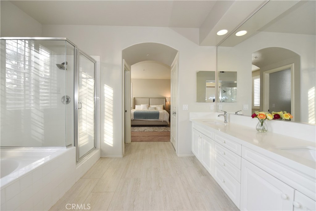 24 Silveroak Irvine, CA 92620 - Photo 41 of 64 a bathroom with a bathtub a mirror a double vanity sink and vanity