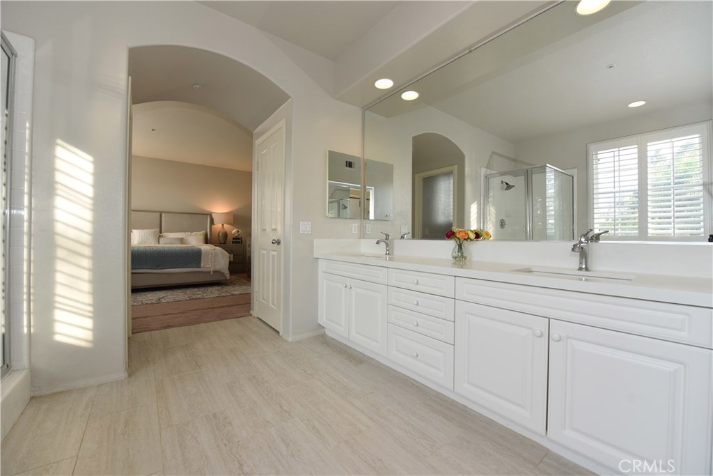24 Silveroak Irvine, CA 92620 - Photo 45 of 64 a en suite bathroom with double sink and a mirror