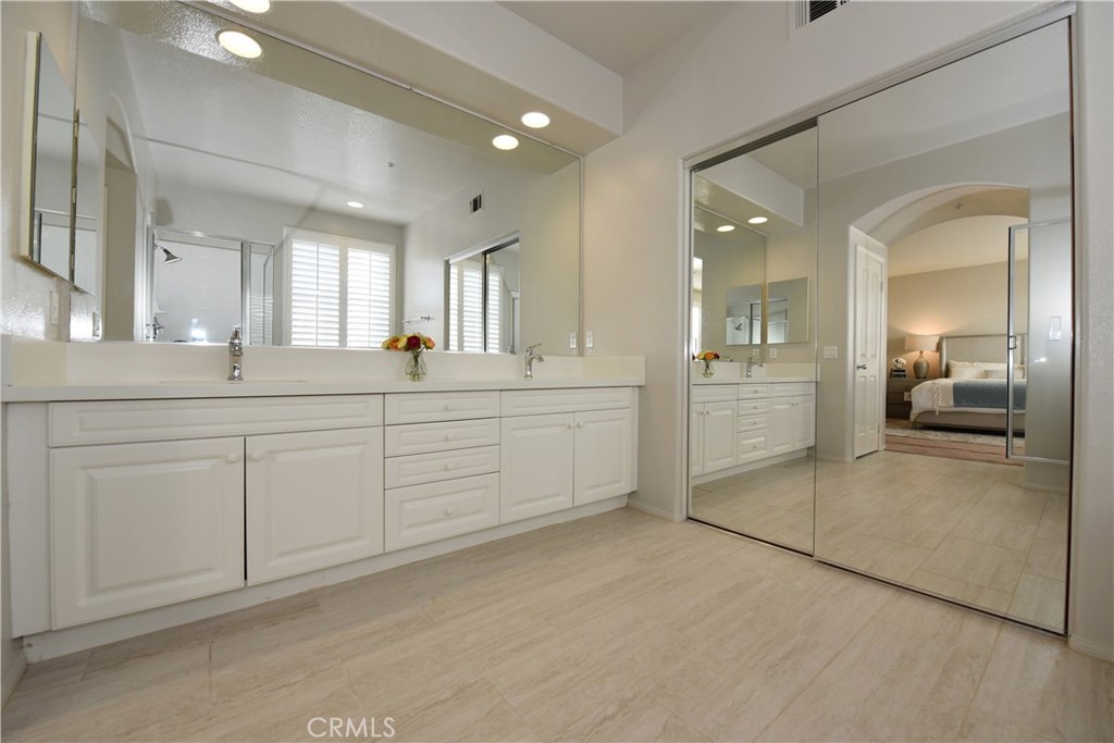 24 Silveroak Irvine, CA 92620 - Photo 46 of 64 a bathroom with a double vanity sink mirror and shower