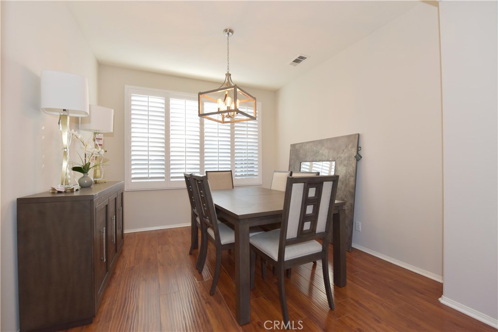 24 Silveroak Irvine, CA 92620 - Photo 10 of 64 a view of a dining room with furniture window and wooden floor