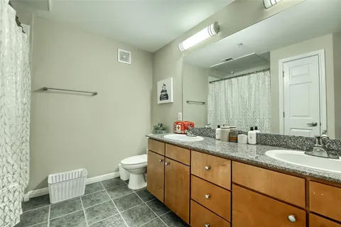 a bedroom with two beds and a chandelier