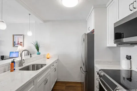 a kitchen with a sink and refrigerator