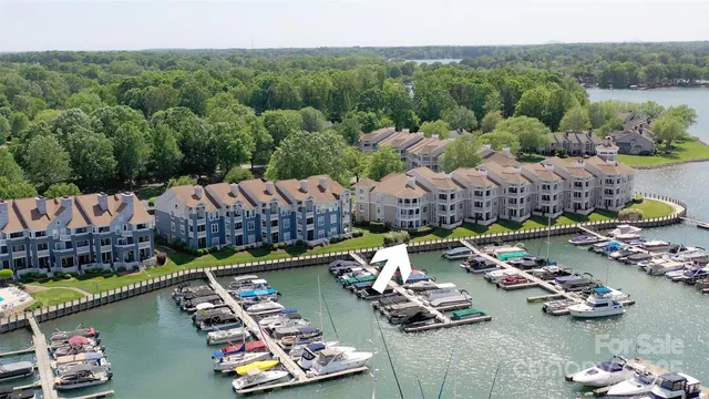 a view of a lake with a house swimming pool and outdoor seating