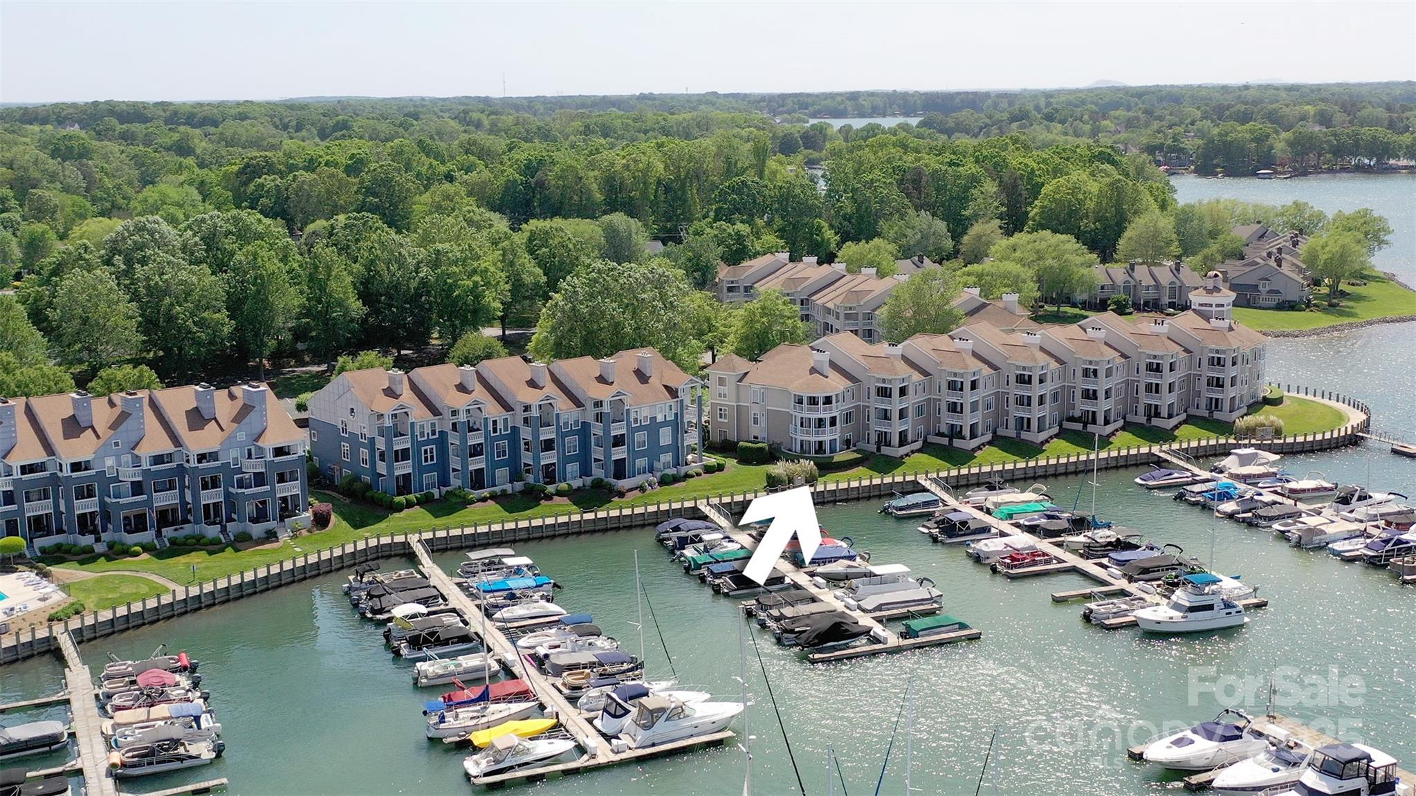 18647 Vineyard Point Lane Cornelius, NC 28031 - Photo 1 of 36 a view of a lake with a house swimming pool and outdoor seating