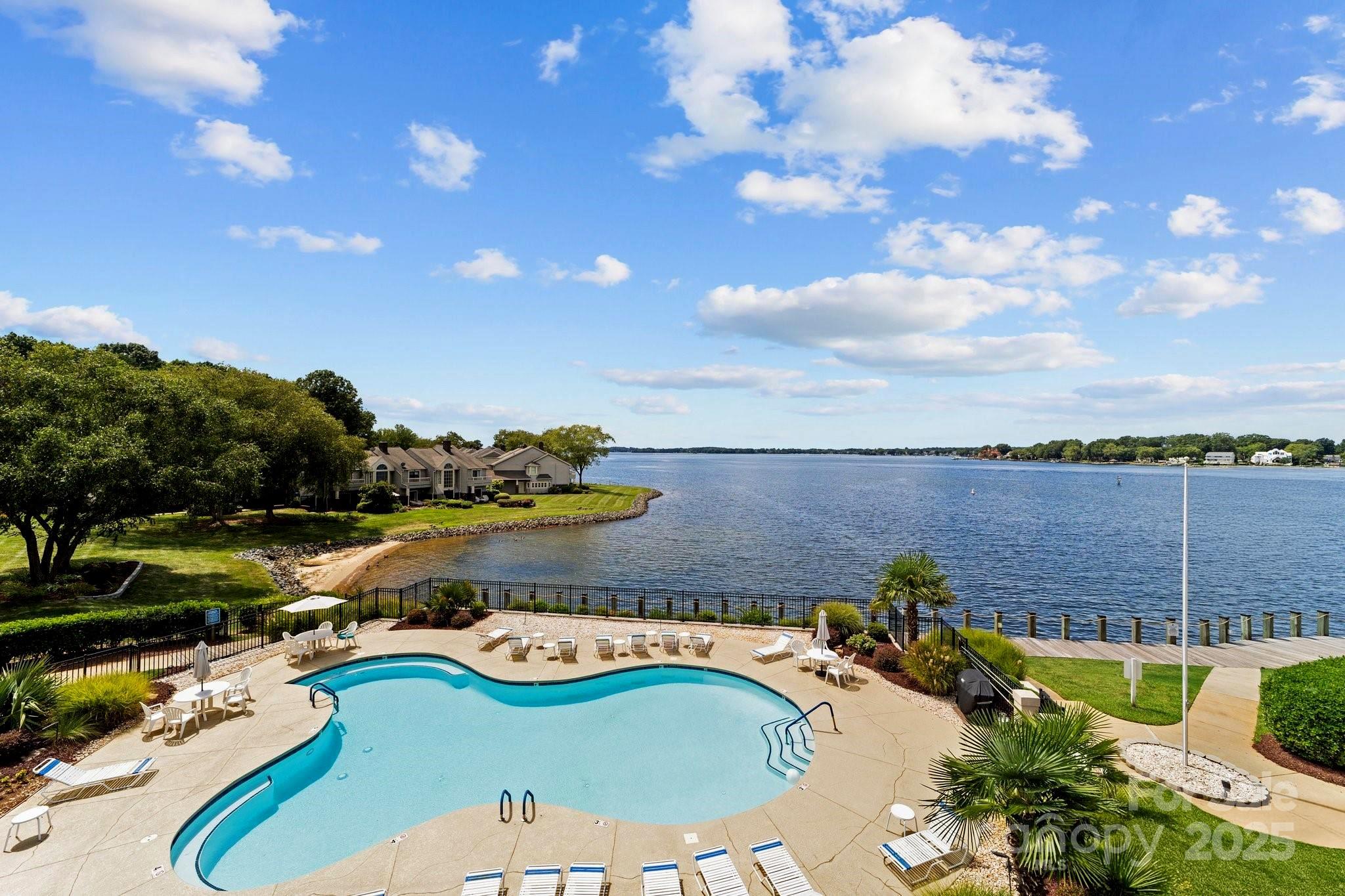 18647 Vineyard Point Lane Cornelius, NC 28031 - Photo 13 of 36 a view of a swimming pool with a yard
